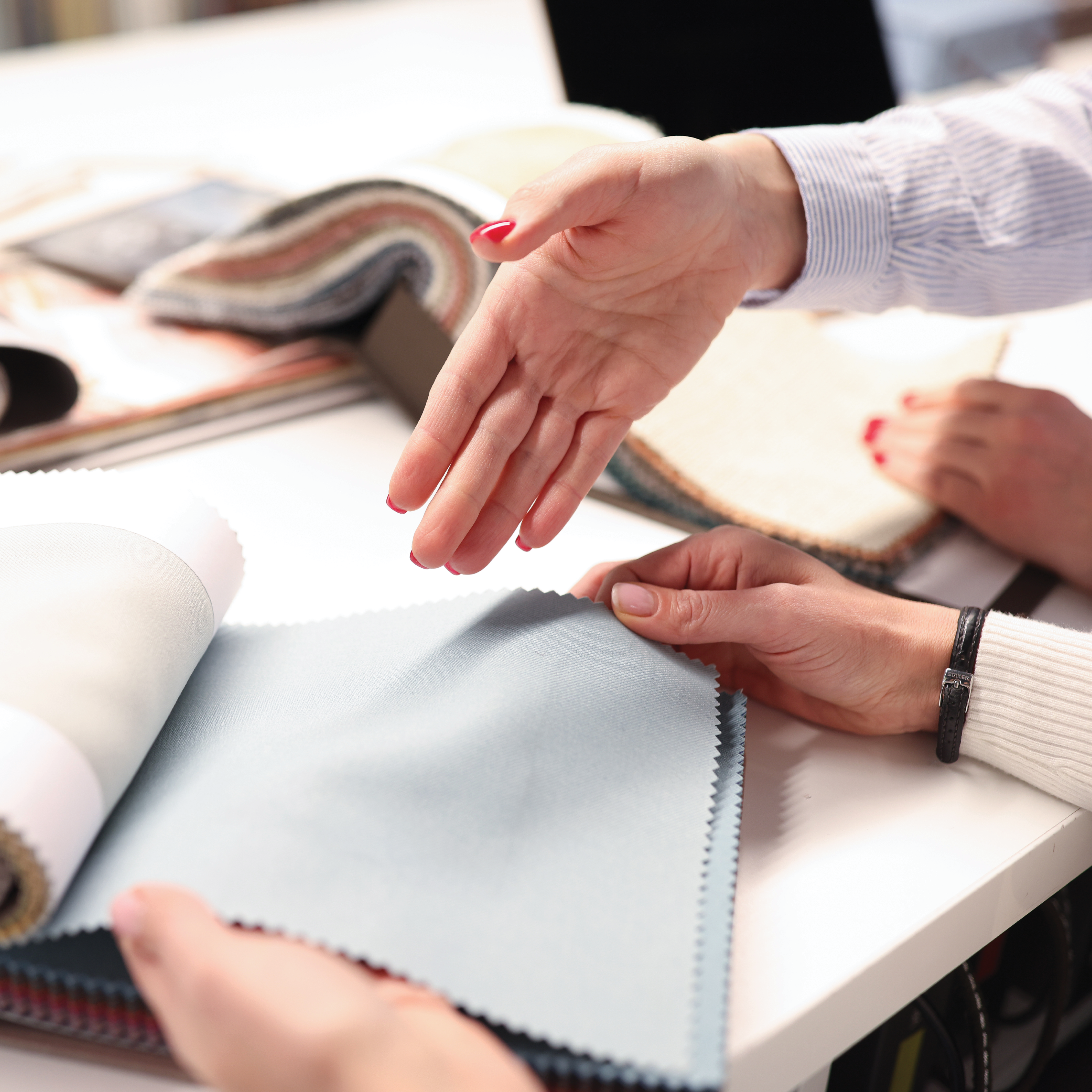 Hand pointing at fabric sample